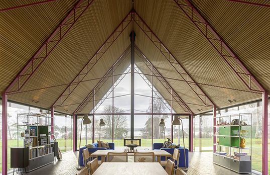 one-storey house interior with pitched wooden roof, large windows