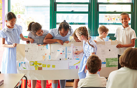 Children with a large planning document