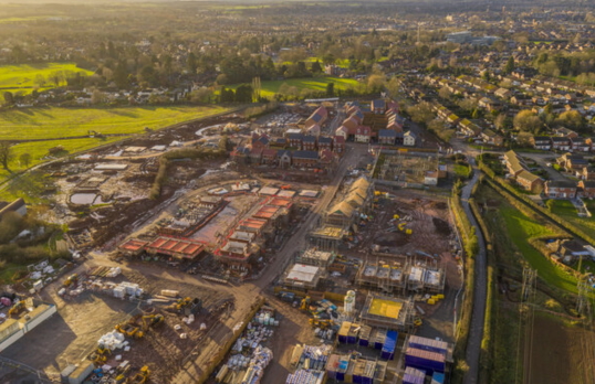 birds eye view of housing estate next to green fields