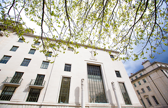 Two people discuss a film shoot in 66 Portland Place