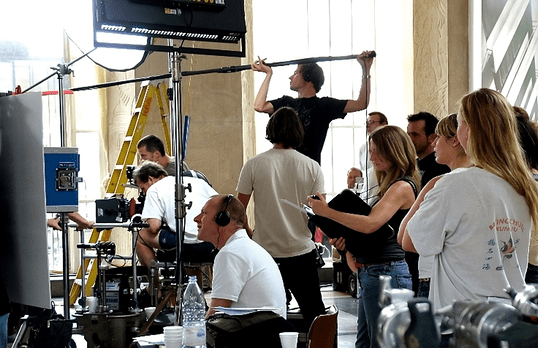 Film crew with large cameras and lighting in the Florence Hall