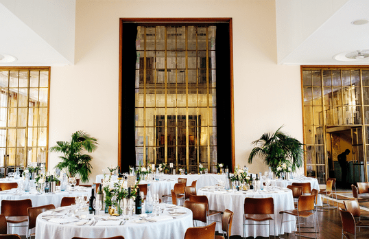 Round wedding tables and centre pieces in the Florence Hall with Art Deco windows at 66 Portland Place
