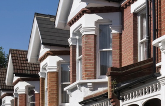 bay windows of brick victorian houses