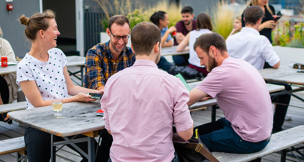 people smiling at picnic table at outdoors event
